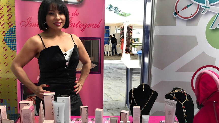 Maria with a table displaying the beauty products she sells