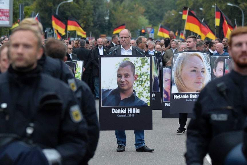 Protester with photo of murdered man Daniel Hillig