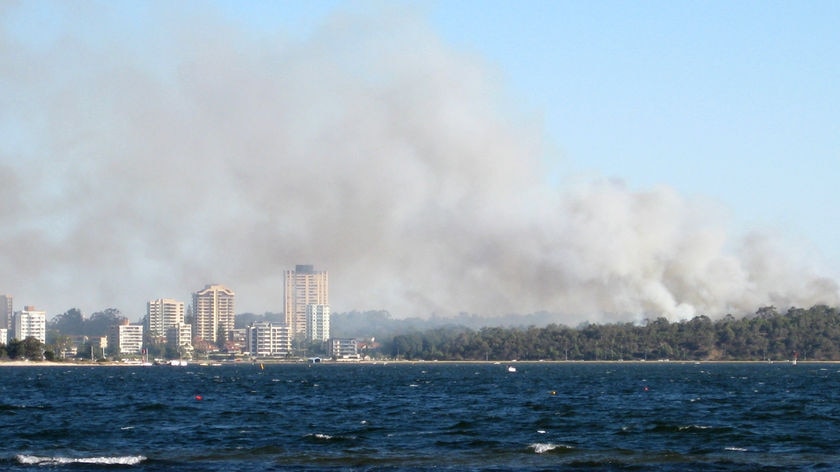 Deliberately lit...smoke billows over the Perth CBD yesterday.