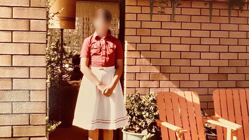 An old photo of a young girl with her face blurred
