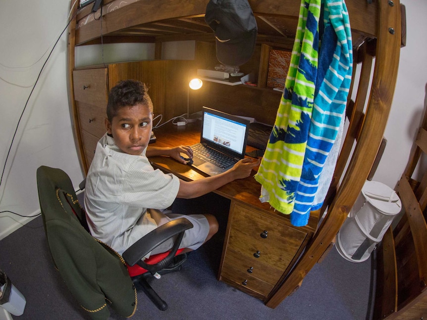 Junior does his homework at the boarding house