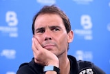 Rafael Nadal rests his chin on his palm as he takes questions at a press conference in Brisbane