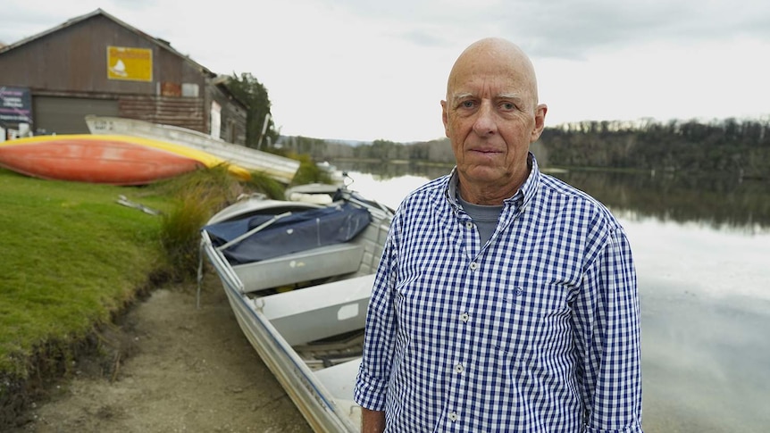 A man in front of a lake.