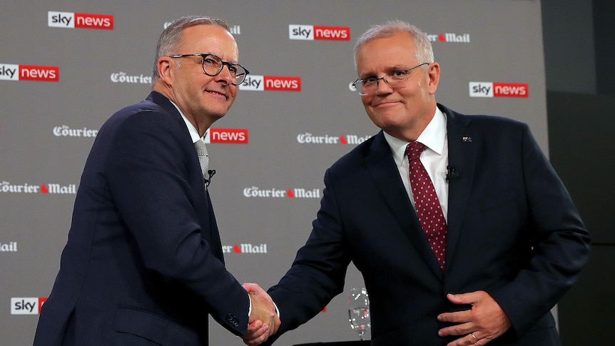 Albanese and Morrison shake hands on stage. 