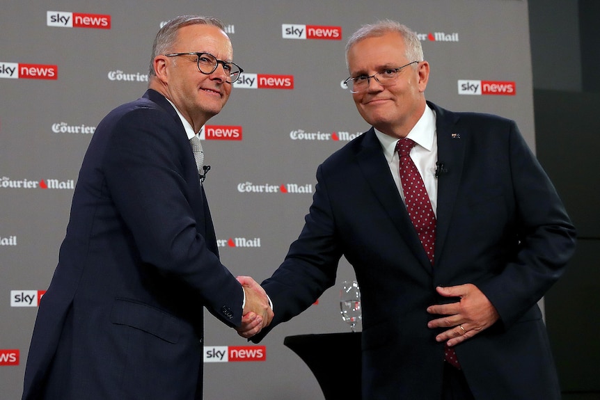 Albanese and Morrison shake hands on stage. 