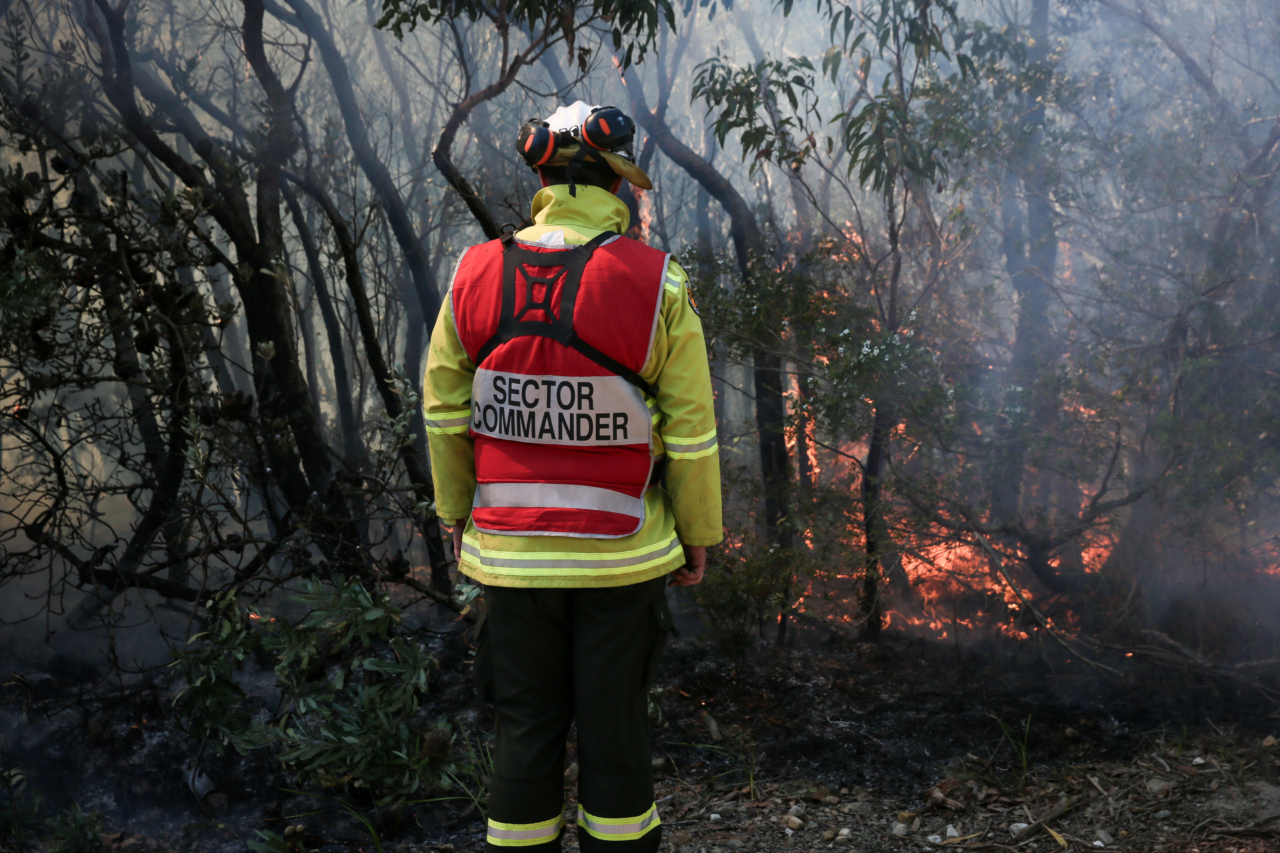 Sector commander stands facing a controlled burn