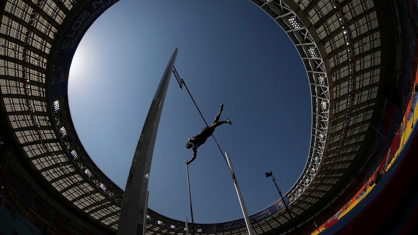 Damian Warner soars over the pole vault bar at the decathlon at the 2013 IAAF World Championships.
