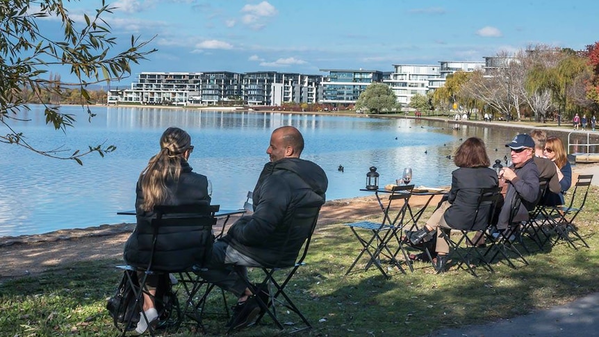 Canberrans enjoy a drink from a temporary bar set up beside Lake Burley Griffin.