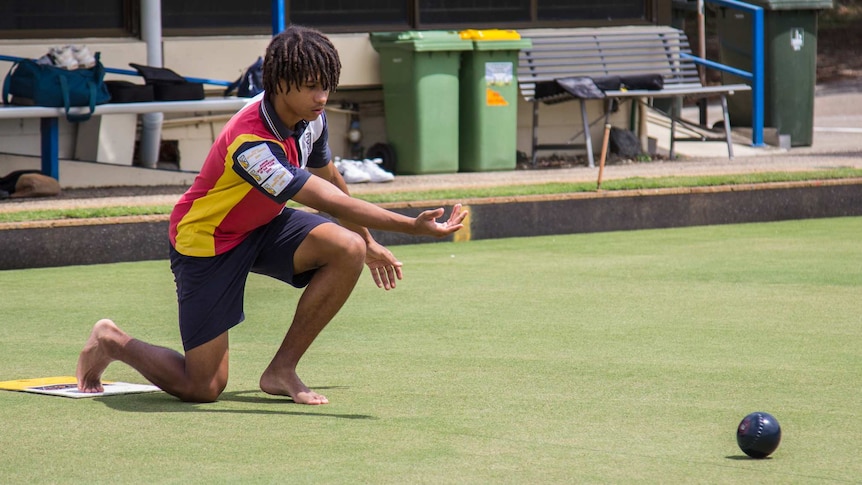 Young teenager plays bowls.