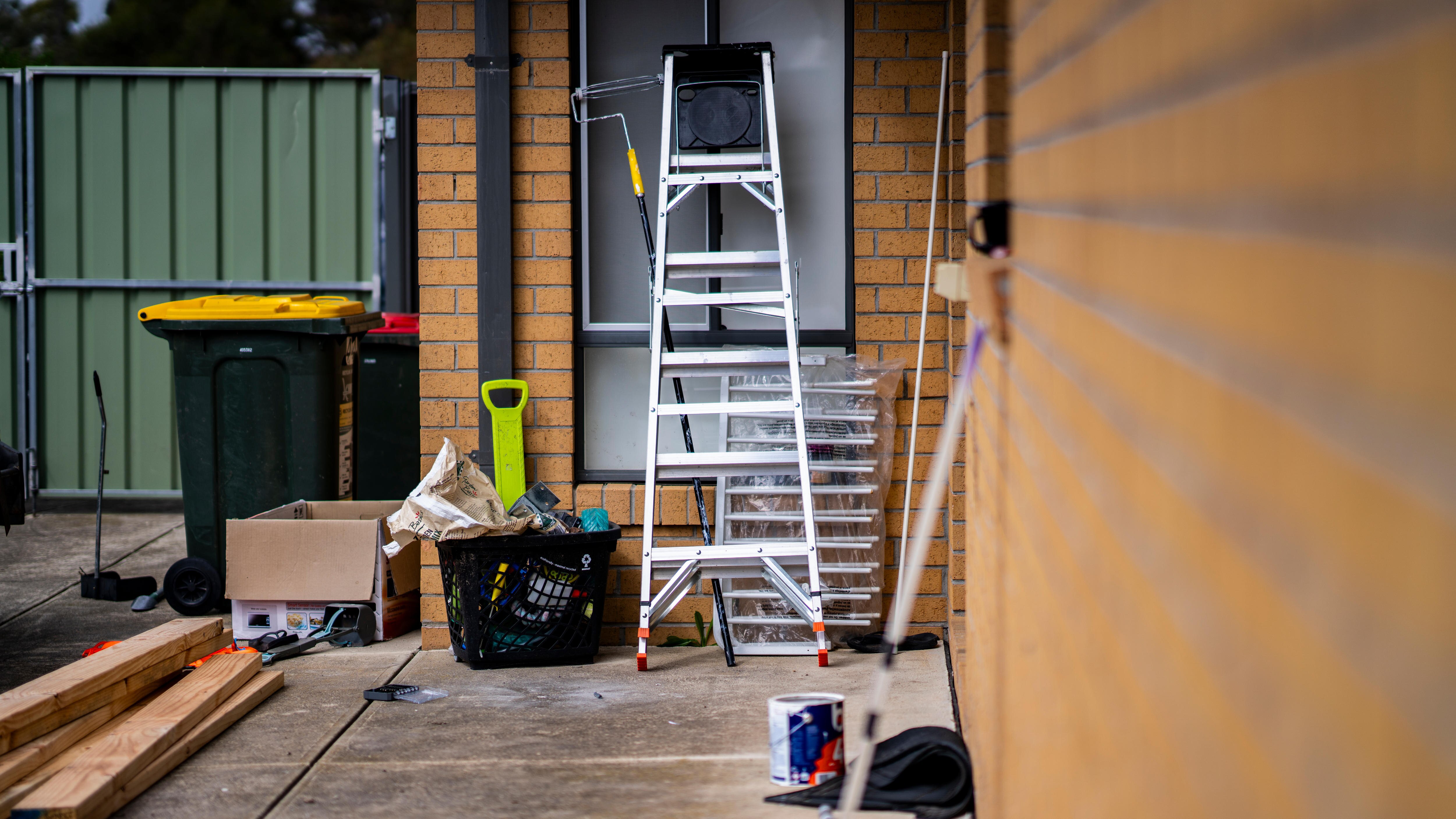 Painting equipment next to a house