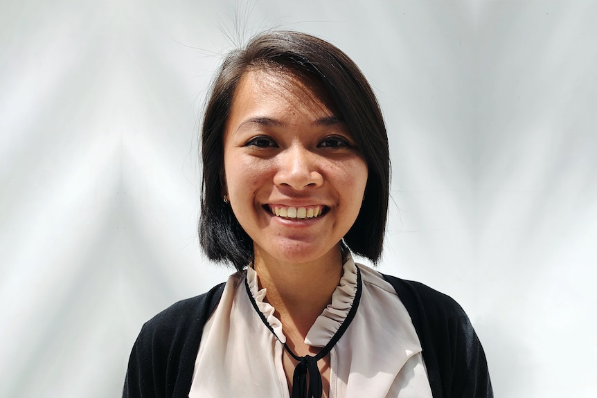 A photo of a young woman of Vietnamese heritage smiling.