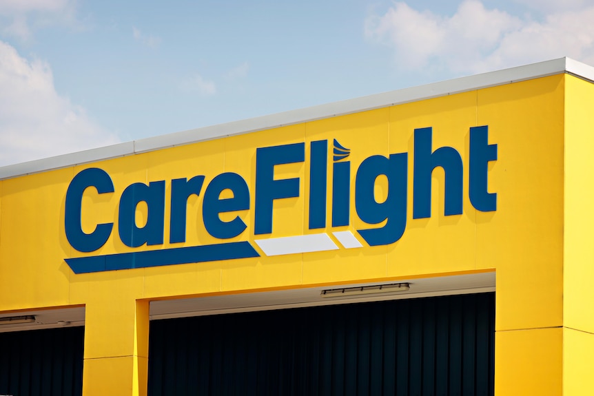 The front of a yellow building featuring 'CareFlight' written in navy blue letters.