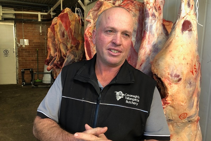 A man stands in his butcher shop