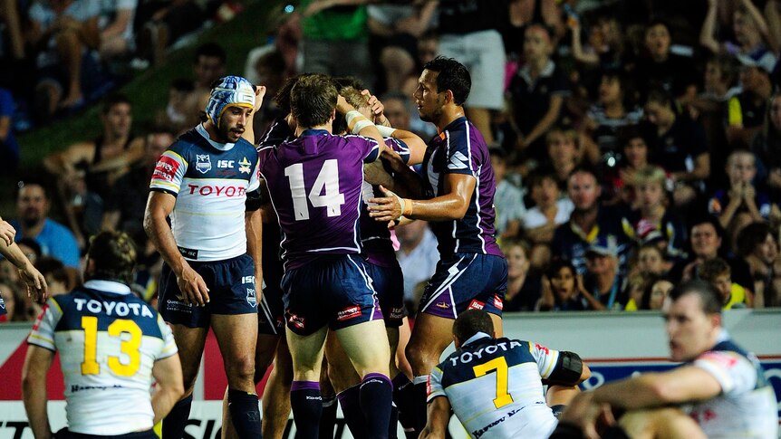 Storm in the tropics ... Melbourne celebrates Ryan Hinchcliffe's try in Townsville.