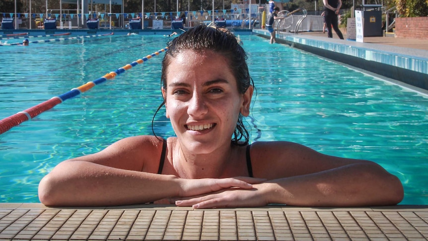 Sophie Bejek smiling at the camera in a swimming pool.