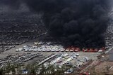 Smoke rises from burning vehicles