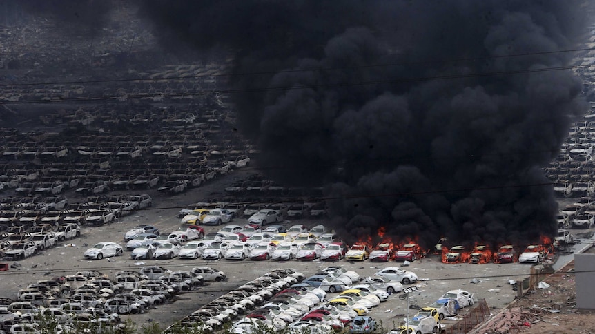 Smoke rises from burning vehicles