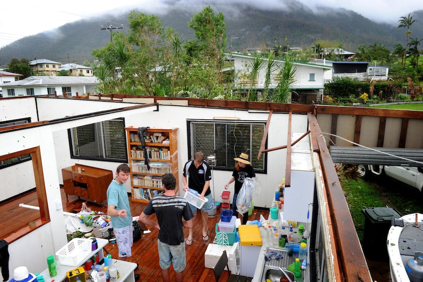 The Balmain family survey damage to their home in Tully