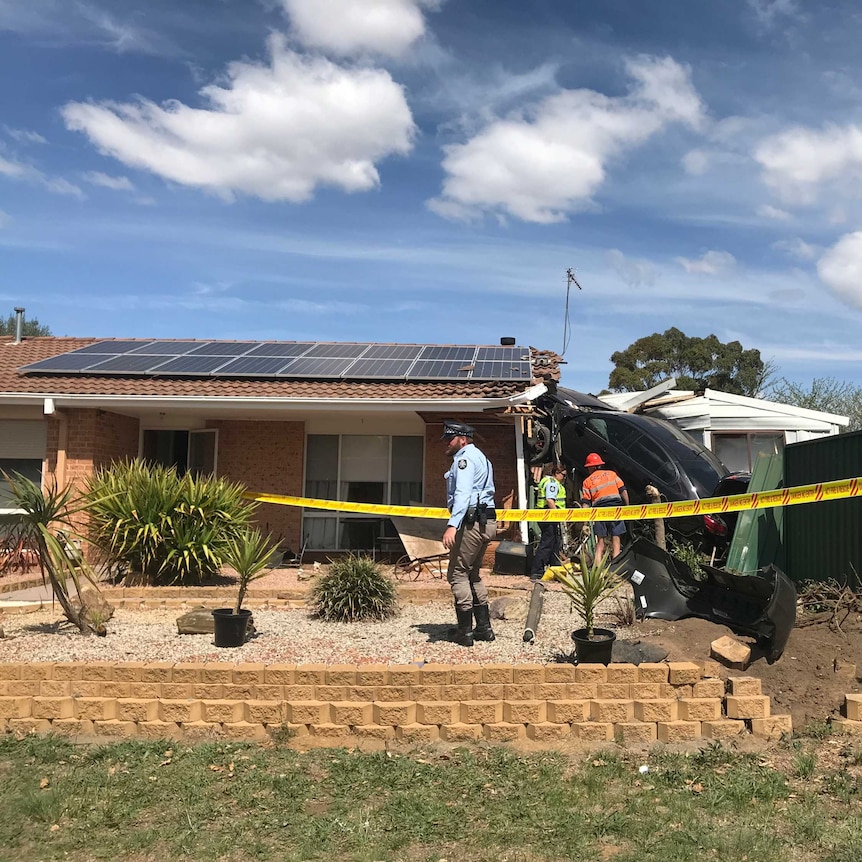 A car sits wedged into a house in Isabella Plains, Canberra.