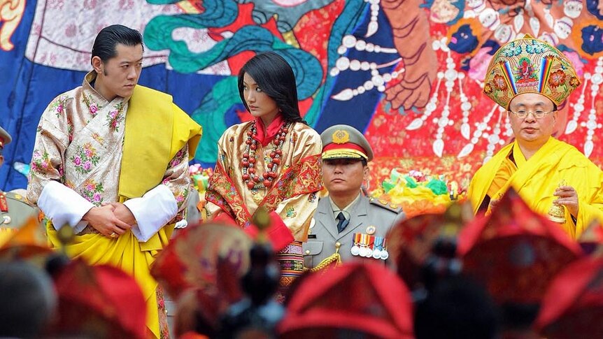 King of Bhutan Jigme Khesar Namgyel Wangchuck and future queen Jetsun Pema stand together during wedding ceremony.