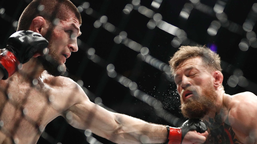Khabib Nurmagomedov (L), punches Conor McGregor in an MMA bout during UFC 229 on October 6, 2018.