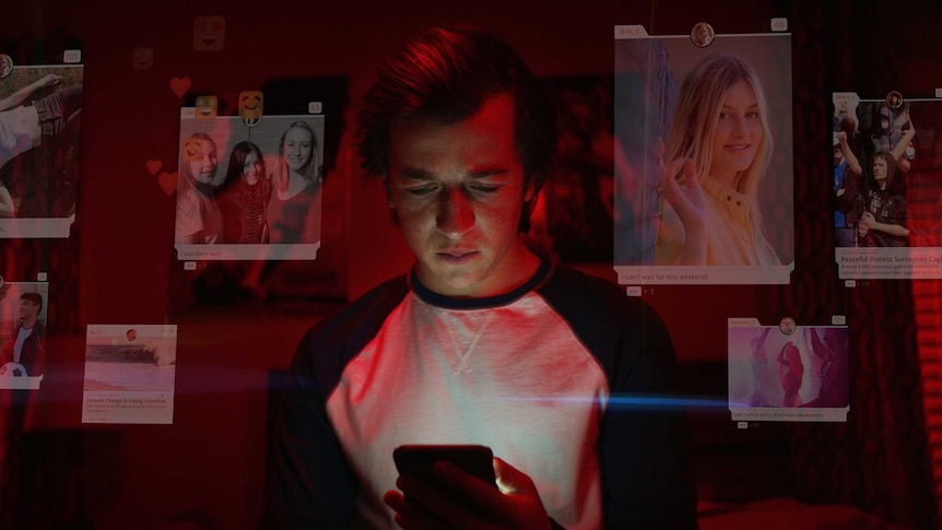 Still from Netflix's The Social Dilemma with man looking at his phone surrounded by social media screens and icons