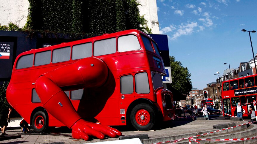 A London bus transformed into a robotic sculpture sits in front of the Czech Olympic headquarters.