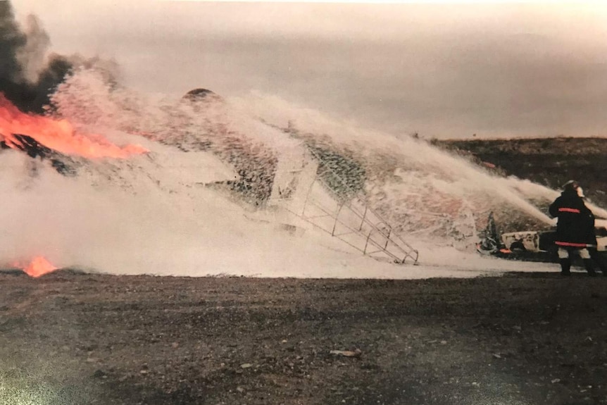 Firefighters use foam to extinguish a fire.