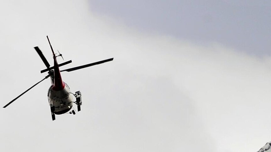 A helicopter flies above the village of Bourg-Saint-Pierre