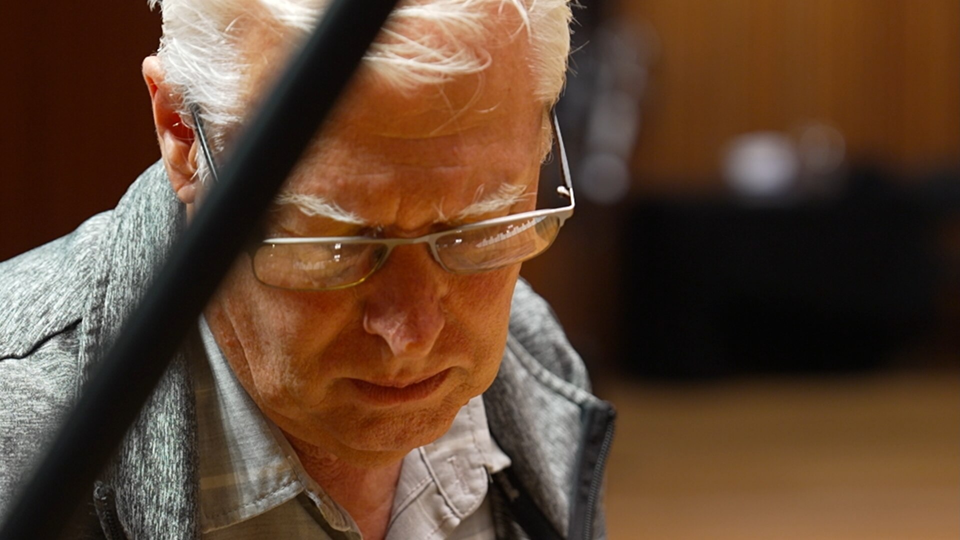 a man looks downward pensively