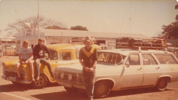 Dated photograph from 1979, three boys sitting on station wagons.