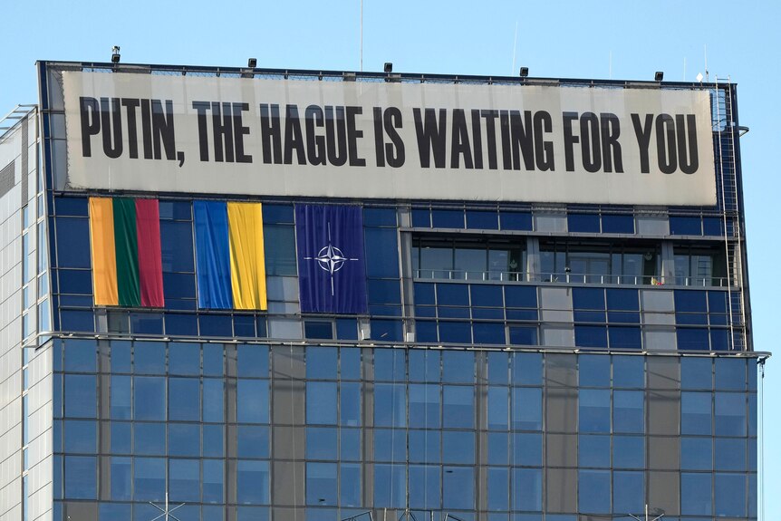 A banner hangs on the upper part of a building in the center of the city during a NATO summit in Vilnius, Lithuania.