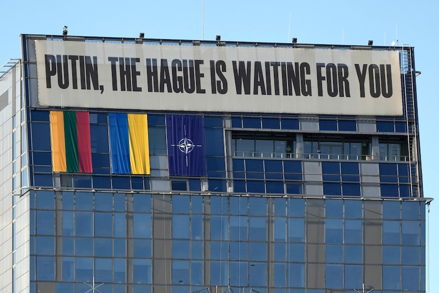 A banner hangs on the upper part of a building in the center of the city during a NATO summit in Vilnius, Lithuania.