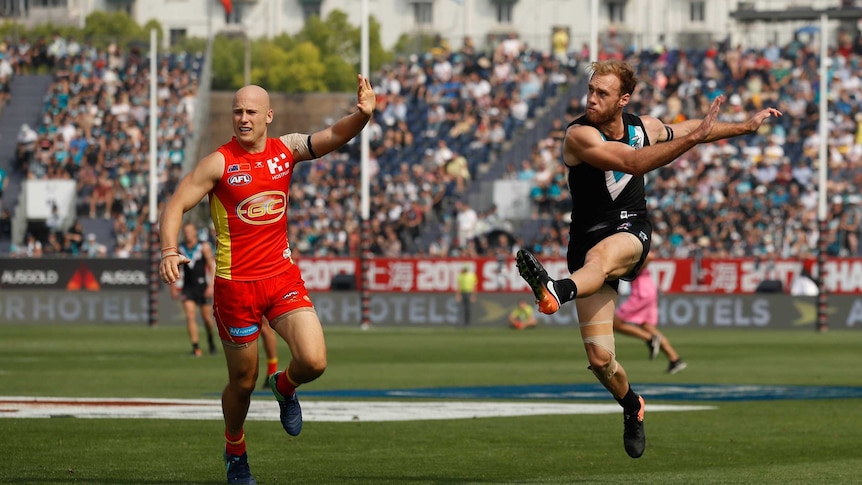 Jack Hombsch playing for Port Adelaide against the Gold Coast Suns in China.