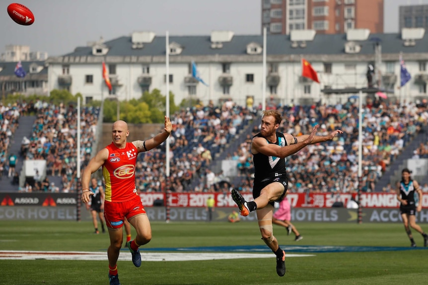 Jack Hombsch playing for Port Adelaide against the Gold Coast Suns in China.
