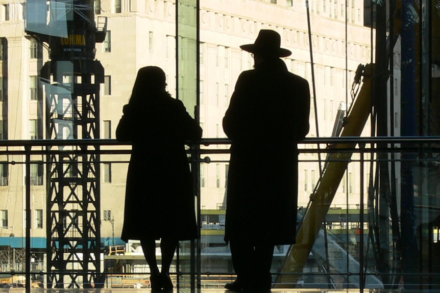 Man and woman walking in building