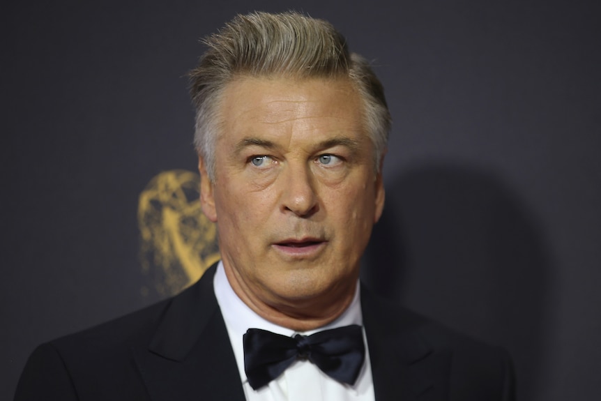 Alec Baldwin looks off camera at a red carpet event