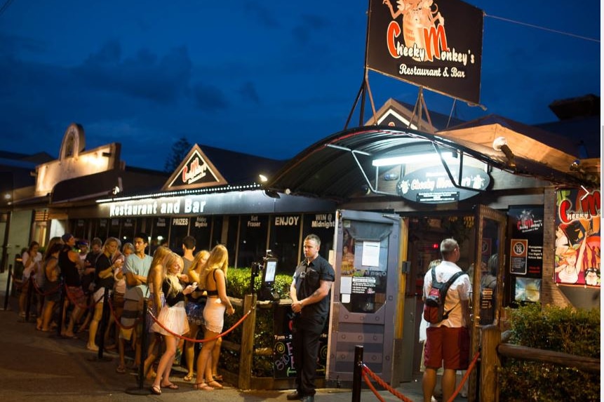 People line up outside a nightclub.