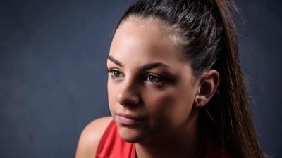 Monique Conti poses for a photograph with a football during the 2017 NAB AFL Women's Draft.