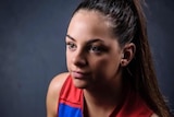 Monique Conti poses for a photograph with a football during the 2017 NAB AFL Women's Draft.