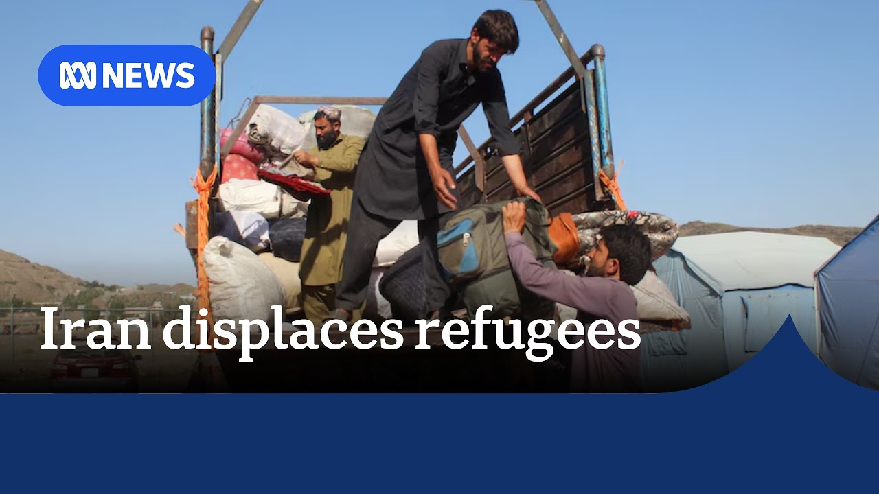 Iran displaces refugees: Afghan refugees load their belongings onto the back of a trailer.