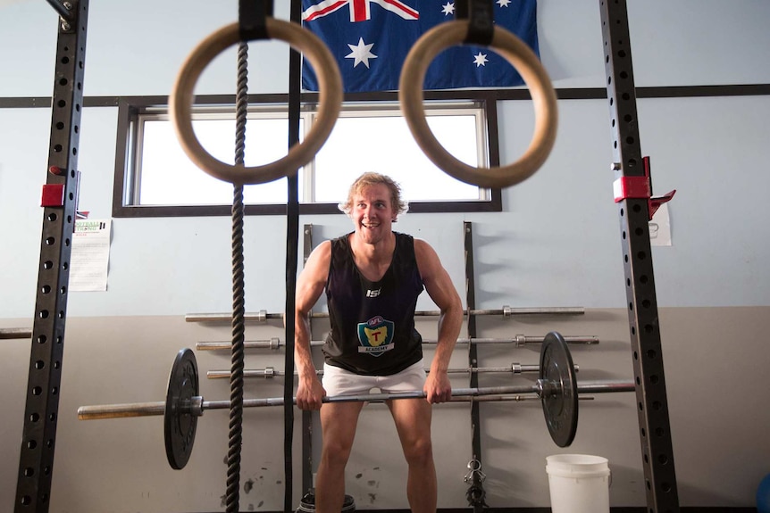 Aspiring AFL footballer training in gym, Tasmania.