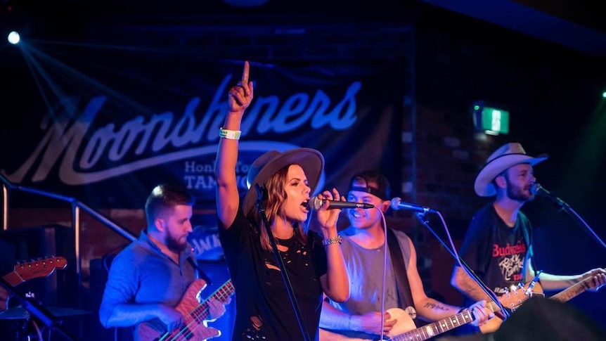 Tori Darke singing on stage