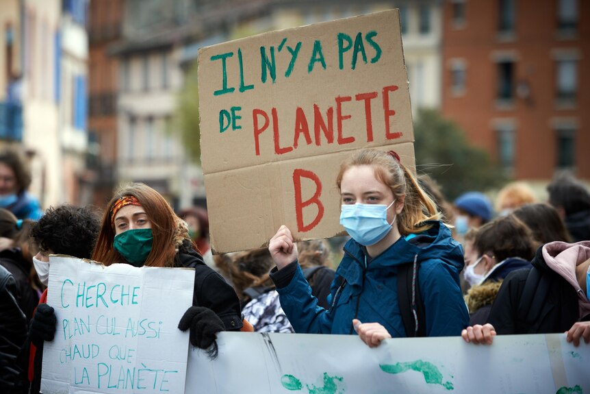A student in Toulouse holds a placard reading "There is no planet B"