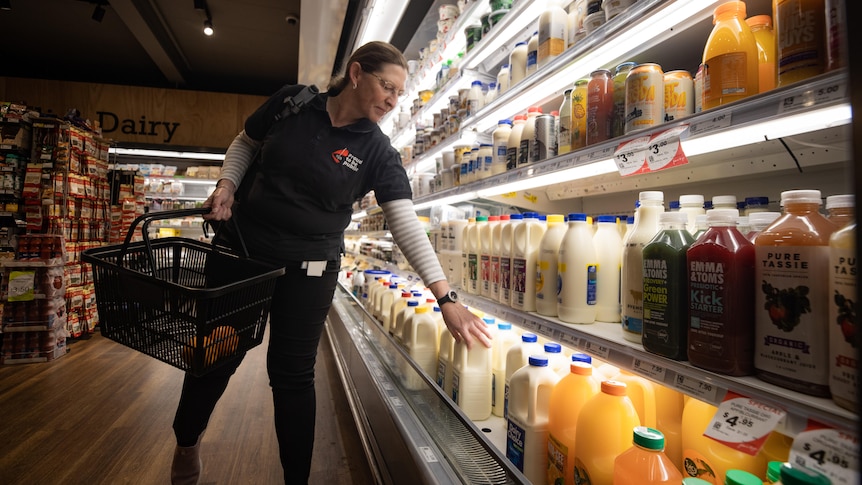 Tasmanian public sector worker Tina Cowen buys milk at the supermarket.