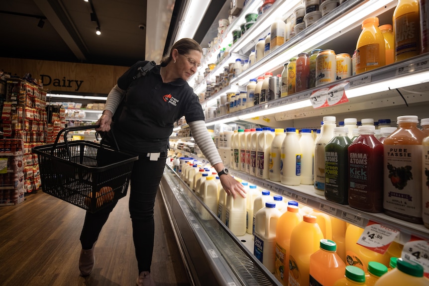 Tasmanian public sector worker Tina Cowen buys milk at the supermarket.