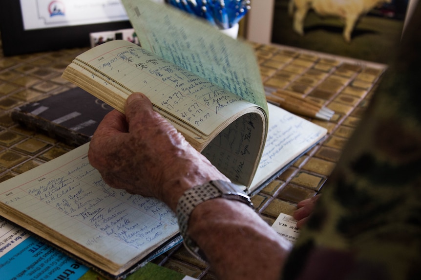 Pages in a handwritten book are turned