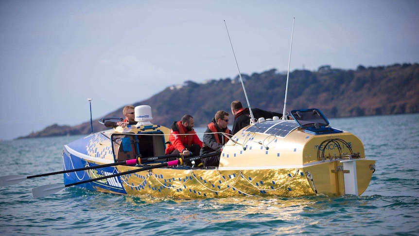 Picture of the crew rowing on the water.