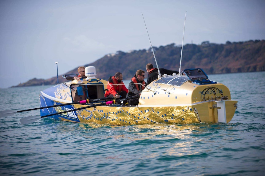 Picture of the crew rowing on the water.