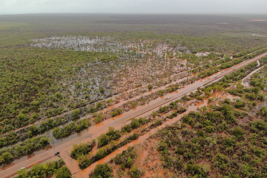 A flooded road and bushland near Broome